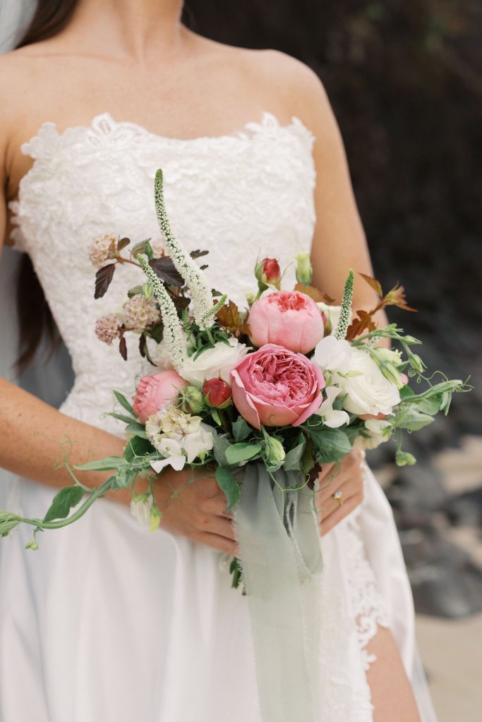 Fragrant David Austin premium garden roses, delicate veronica, delightful and airy sweetpeas, and other seasonal blooms in a dreamy color palette of dusty rose, blush and white, finished with soft flowing ribbon.
