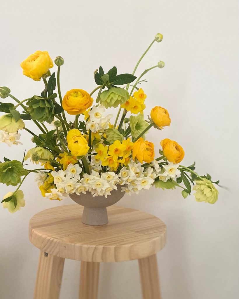 A bright pop of yellow ranunculus and soft lemony jonquils combined with Helleborus designed by Hart and Flowers based in Alexandra Hills on the Redlands Coast.
