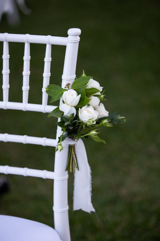 Classic white spray roses with lush greenery create a timeless and romantic pew end decoration for your wedding ceremony. Expertly arranged blooms by Hart and Flowers to add a touch of elegance to any aisle finished with a soft flowing ribbon.